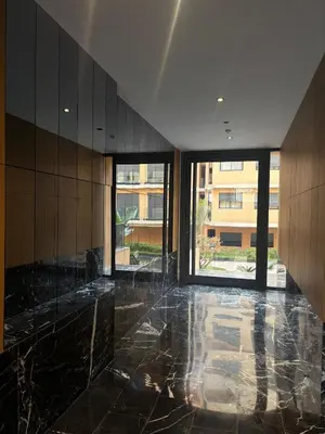 an empty lobby with black marble floors and windows at Appartement Gueliz Elite garden in Marrakech