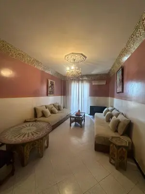a living room with two couches and a chandelier at Appartement Layane Votre havre de paix à deux pas de Guéliz in Marrakech