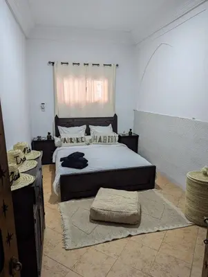 a bedroom with a large bed and a window at Atelier des Reeves in Marrakech
