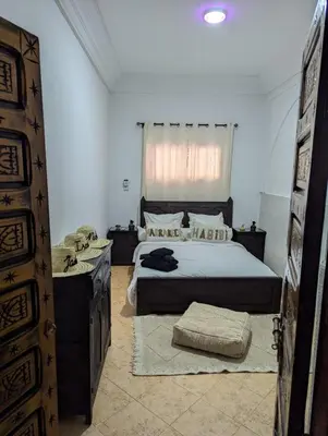 a bedroom with a large bed and a window at Atelier des Reeves in Marrakech