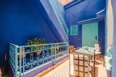 a blue room with a balcony and a blue wall at Riad Alzira Jardin Secret Au coeur De La Medina in Marrakech