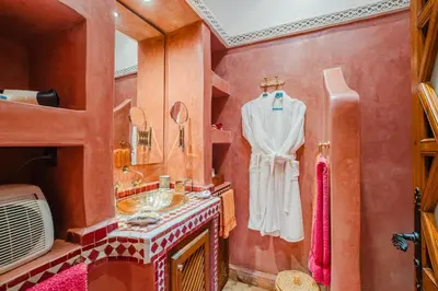 a bathroom with a sink and a mirror at Riad Alzira Jardin Secret Au coeur De La Medina in Marrakech