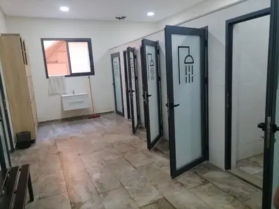 a row of doors in a room with a tile floor at jnane ali akioud Gueliz in Marrakech