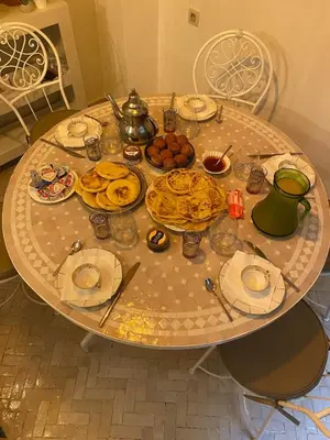 a table with plates of food on it at Riad Médina Bienvenue in Marrakech