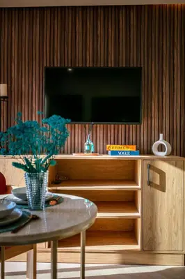 a living room with a tv and a table at AYLAL Marrakech in Marrakech