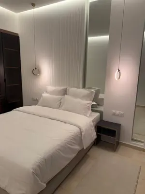 a bedroom with a large bed with white sheets and pillows at Appartement moderne in Marrakech