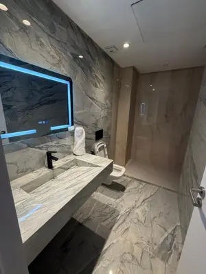 a bathroom with a sink and a shower and a television at Appartement moderne in Marrakech