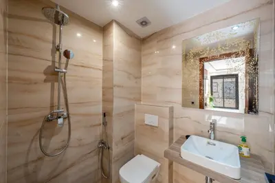 a bathroom with a shower and a toilet and a sink at Chic 2BR apartment wifi balcon in Marrakech