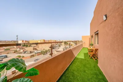 a balcony of a building with a green lawn at Chic 2BR apartment wifi balcon in Marrakech