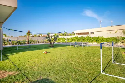 a soccer field with a goal in the grass at Villa Luxe Neuve , Piscine XXL , Sans vis-à-vis in Marrakech