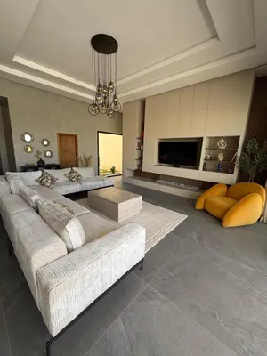 a living room with two couches and a television at Villa ALIYAH in Marrakech