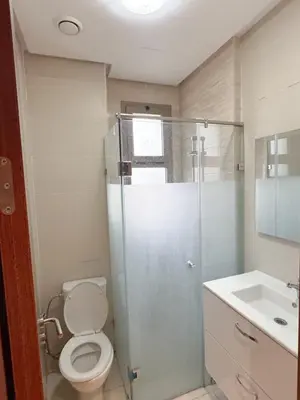a bathroom with a shower and a toilet and a sink at The Golf Pool Gardens in Marrakech