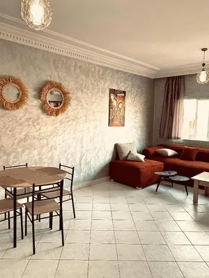 a living room with a couch and a table at cosy terasse apartement in Marrakech