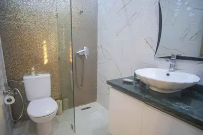 a bathroom with a toilet and a sink at Villa B with a private pool in Oulad Ikhia