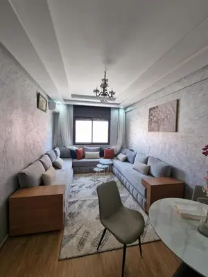 a living room with a couch and a table at Modern Fully equipped 2 rooms apartment in Marrakech