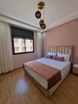 a bedroom with a large bed and a window at Modern Fully equipped 2 rooms apartment in Marrakech