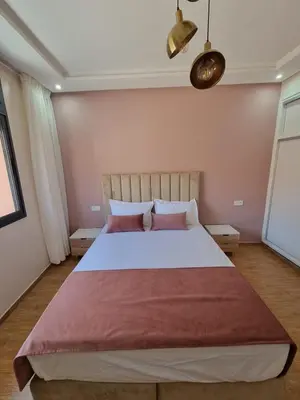 a bedroom with a large bed with two pillows at Modern Fully equipped 2 rooms apartment in Marrakech