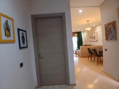 a door in a room with a living room at Appartement Prestigia Marrakech Maroc Golf Piscine in Marrakech