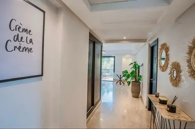 a hallway with a white wall with a picture on it at Generosa studio in Marrakech