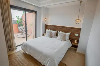 a bedroom with a white bed and a balcony at Generosa studio in Marrakech