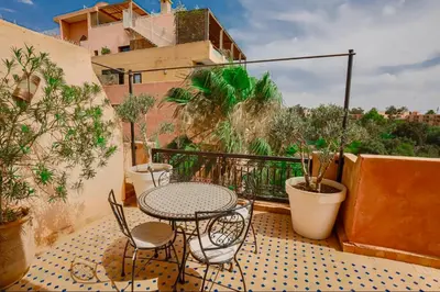 a patio with a table and chairs on a balcony at Generosa studio in Marrakech