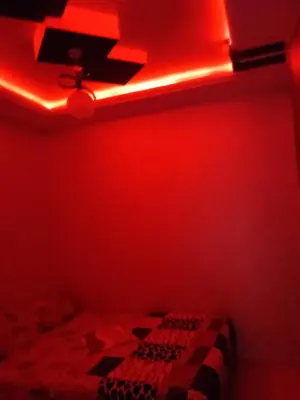 a red room with a bed and a red light at Apartment marakech geluz in Marrakech