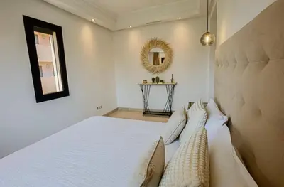 a bedroom with a large white bed with pillows at Generosa 22 in Marrakech