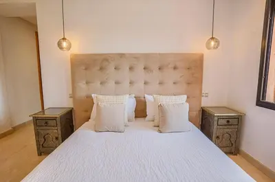 a bedroom with a large white bed with two night stands at Generosa 22 in Marrakech