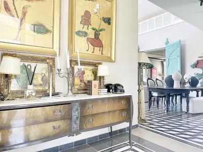 a dining room with a table and a wooden dresser at Yasira in Marrakech