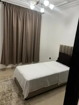 a bedroom with a white bed and a window at Apartement Mabrouka in Marrakech