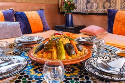a table with a plate of food on it at Riad Mazouz102 Médina in Marrakech