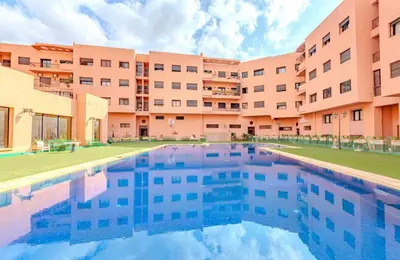 a swimming pool in front of a building at AliZ Appartement 2 chambres avec piscine, Majorelle in Marrakech