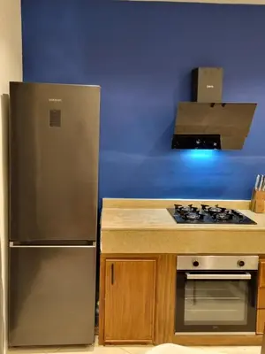 a kitchen with a stainless steel refrigerator and a stove at Entire Luxury Duplex Appart 3Bedroom 2Living Rooms in Top Center in Marrakech