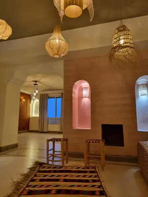 a living room with two chairs and a fireplace at Entire Luxury Duplex Appart 3Bedroom 2Living Rooms in Top Center in Marrakech