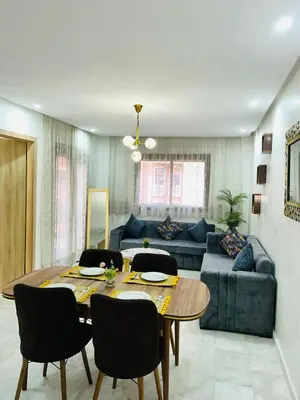a living room with a table and a couch at Appartement Gueliz in Marrakech