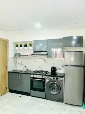 a kitchen with a stove and a washing machine at Appartement Gueliz in Marrakech