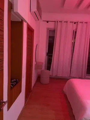 a pink room with a bed and a toilet at Oasis Luxury Villa Marrakesh in Marrakech
