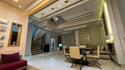 a dining room with a table and chairs at Oasis Luxury Villa Marrakesh in Marrakech