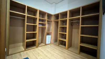 a walk in closet with lots of wooden shelves at Oasis Luxury Villa Marrakesh in Marrakech
