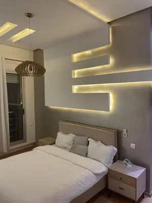 a bedroom with a white bed and a light at Oasis Luxury Villa Marrakesh in Marrakech