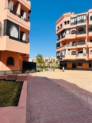 a brick walkway in front of a building at Apparemment première village in Marrakech