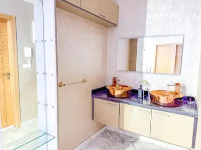 a bathroom with two sinks and a mirror at Villa with private pool in Marrakech