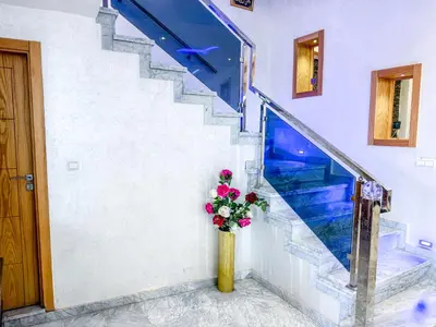 a vase filled with flowers sitting next to a staircase at Villa with private pool in Marrakech