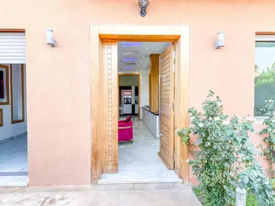 an open door of a building with a pink wall at Villa with private pool in Marrakech