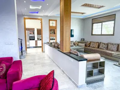 a living room with pink furniture and a lobby at Villa with private pool in Marrakech