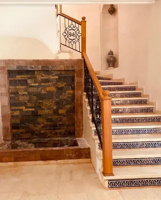 a staircase in a home with a brick wall at Villa privée in Marrakech