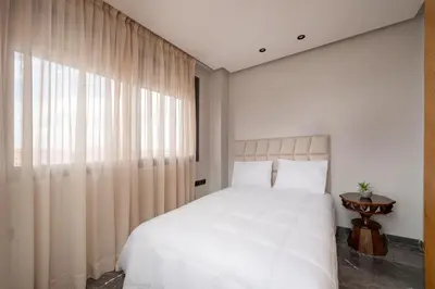 a bedroom with a white bed and a window at 3Br 2Ba Apartment in Marrakech in Marrakech