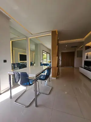 a dining room with a table and blue chairs at Luxury appartment hivernage in Marrakech