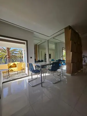 a dining room with a table and chairs at Luxury appartment hivernage in Marrakech