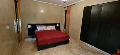a bedroom with a bed with a red blanket at Riad-Style Villa in Marrakech in Marrakech